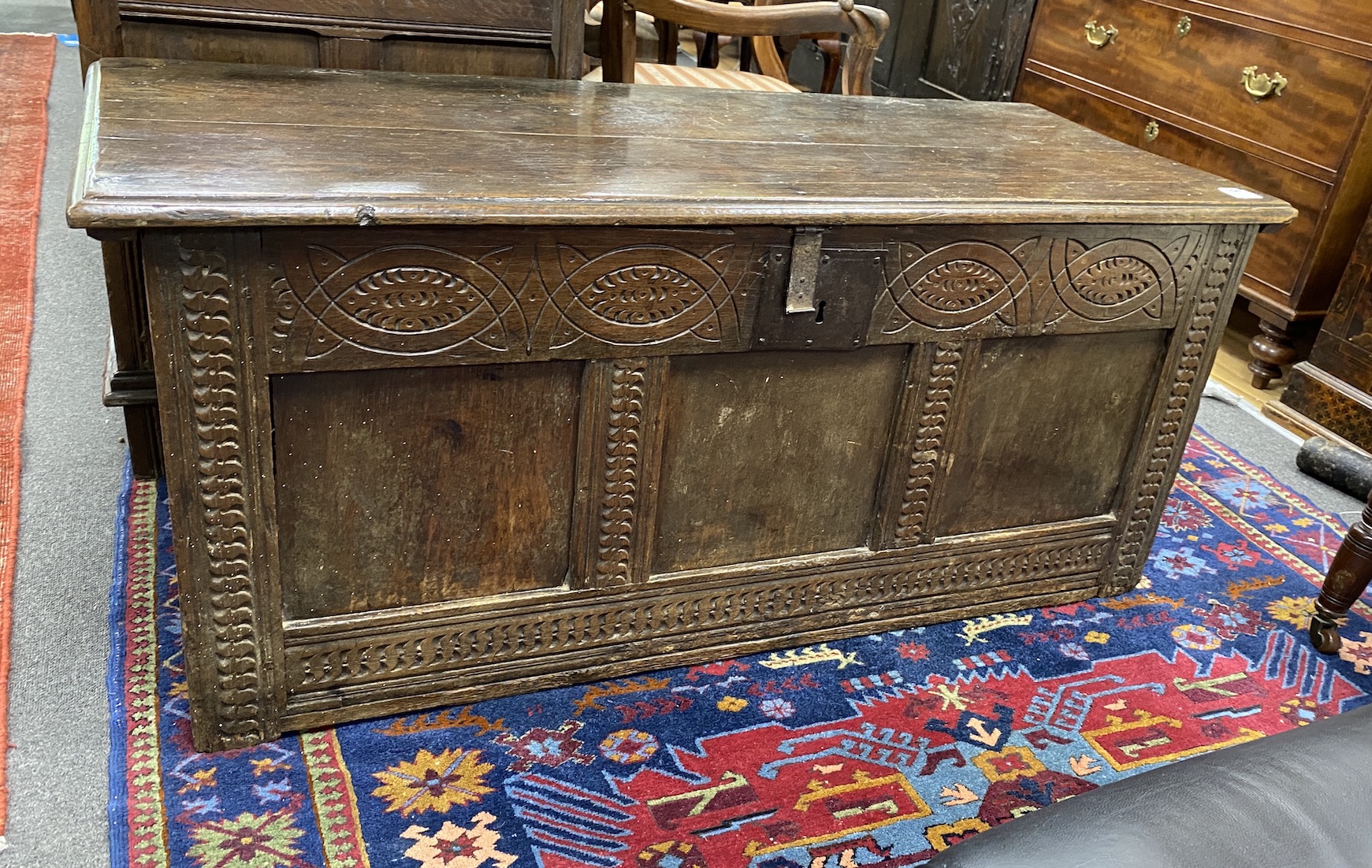 A large carved oak panelled coffer, length 131cm, depth 54cm, height 56cm